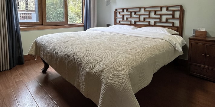 A secluded side entrance leads to the second floor of Yangshuo Mountain Retreat where a double queen bed room affords stunning views of the Yulong River. Find out why we are consistently among top Yangshuo hotels for 17 years.