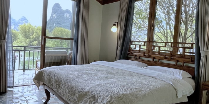 A secluded side entrance leads to the second floor of Yangshuo Mountain Retreat where a double queen bed room affords stunning views of the Yulong River. Find out why we are consistently among top Yangshuo hotels for 17 years.
