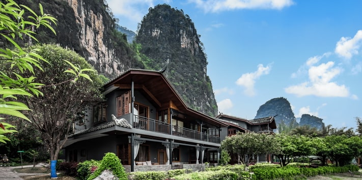 A secluded side entrance leads to the second floor of Yangshuo Mountain Retreat where a double queen bed room affords stunning views of the Yulong River. Find out why we are consistently among top Yangshuo hotels for 17 years.